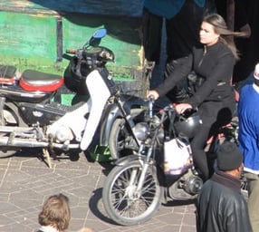 GIrl on scooter (detail from Marrakech market image)