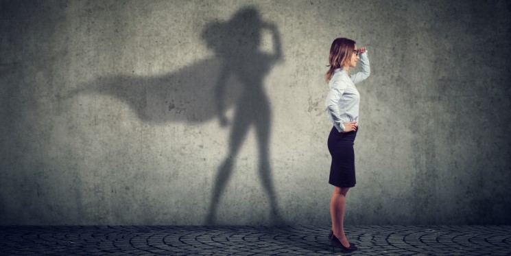 A shadow of a business woman as caped crusader